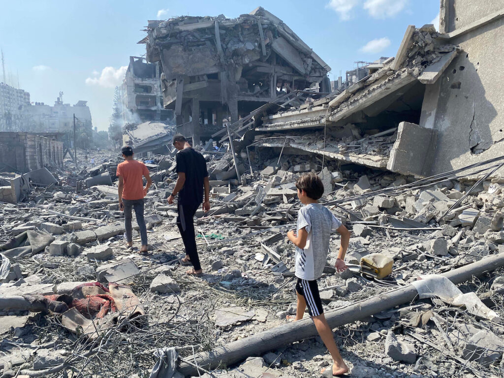 palestinians inspect the damage following an israeli airstrike on the el remal area in gaza city