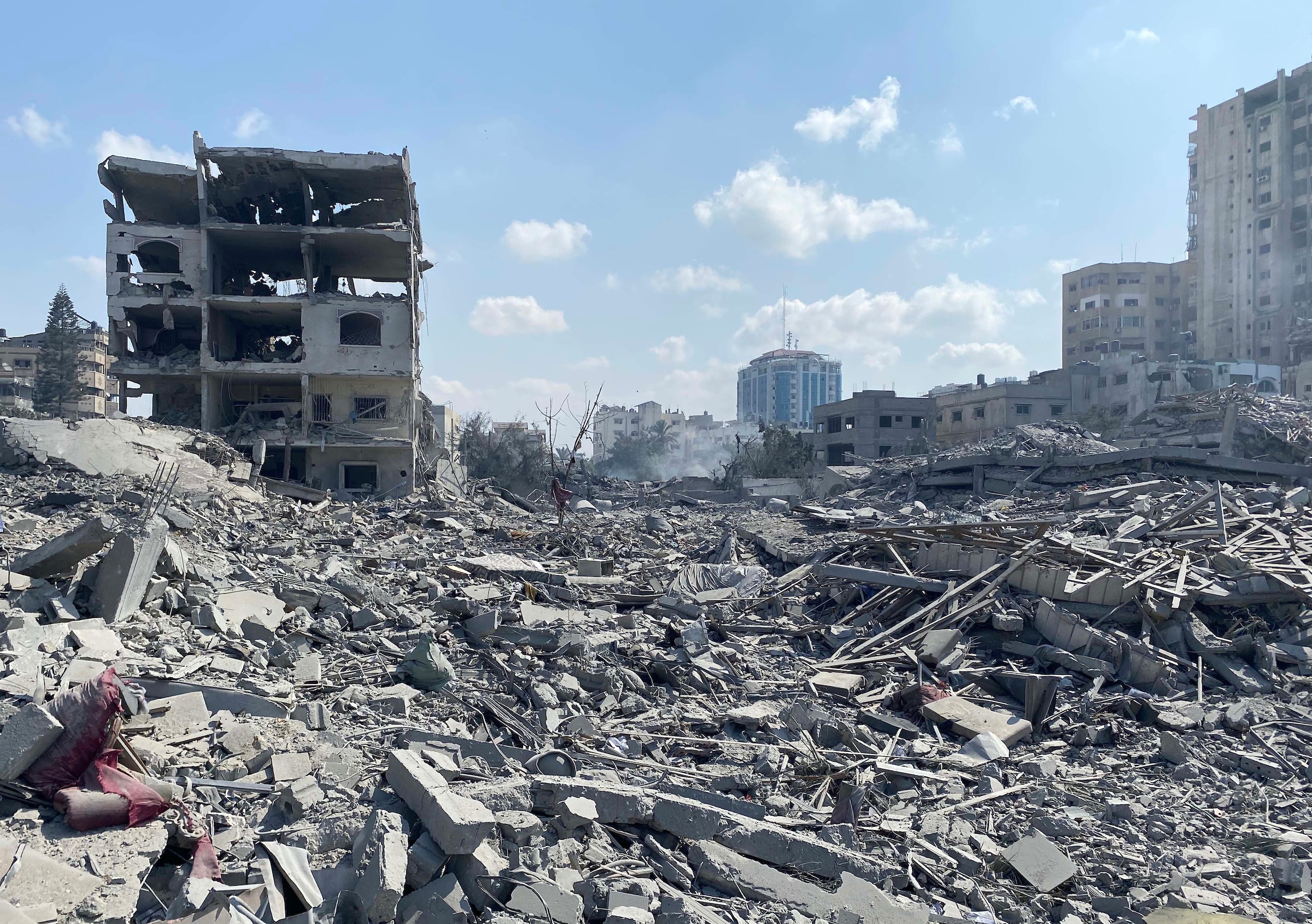 palestinians inspect the damage following an israeli airstrike on the el remal area in gaza city